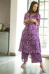 Model posing and twirling in a purple, tie-and-dye Kurta.