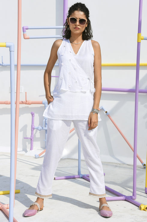 Woman wearing a stylish white top.