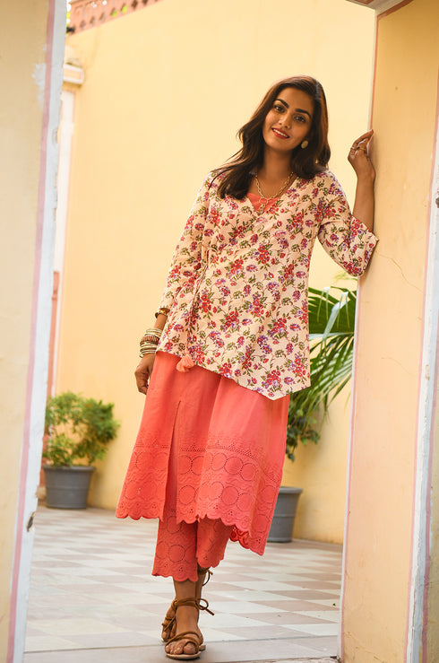 Model looking at the camera, wearing a floral top for girls.