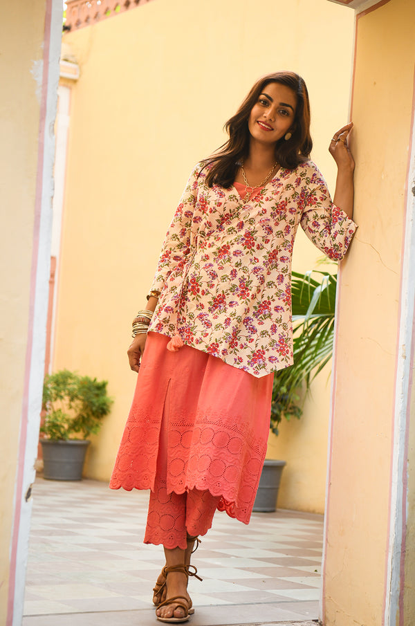 Model looking at the camera, wearing a floral top for girls.