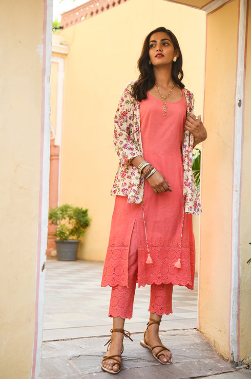 Model looking at the camera, wearing a floral top for girls.