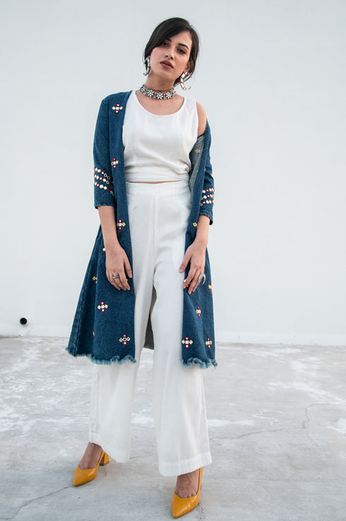 Model wearing a white crop top by Gulaal.