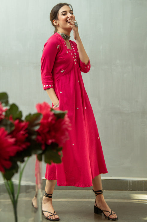 Model wearing pink fit and flare dress.